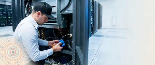 Engineer diagnosing a CRAC unit fault on a precision cooling controller