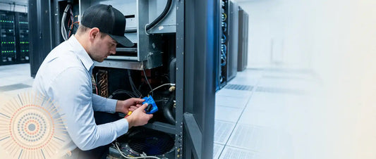 Engineer diagnosing a CRAC unit fault on a precision cooling controller